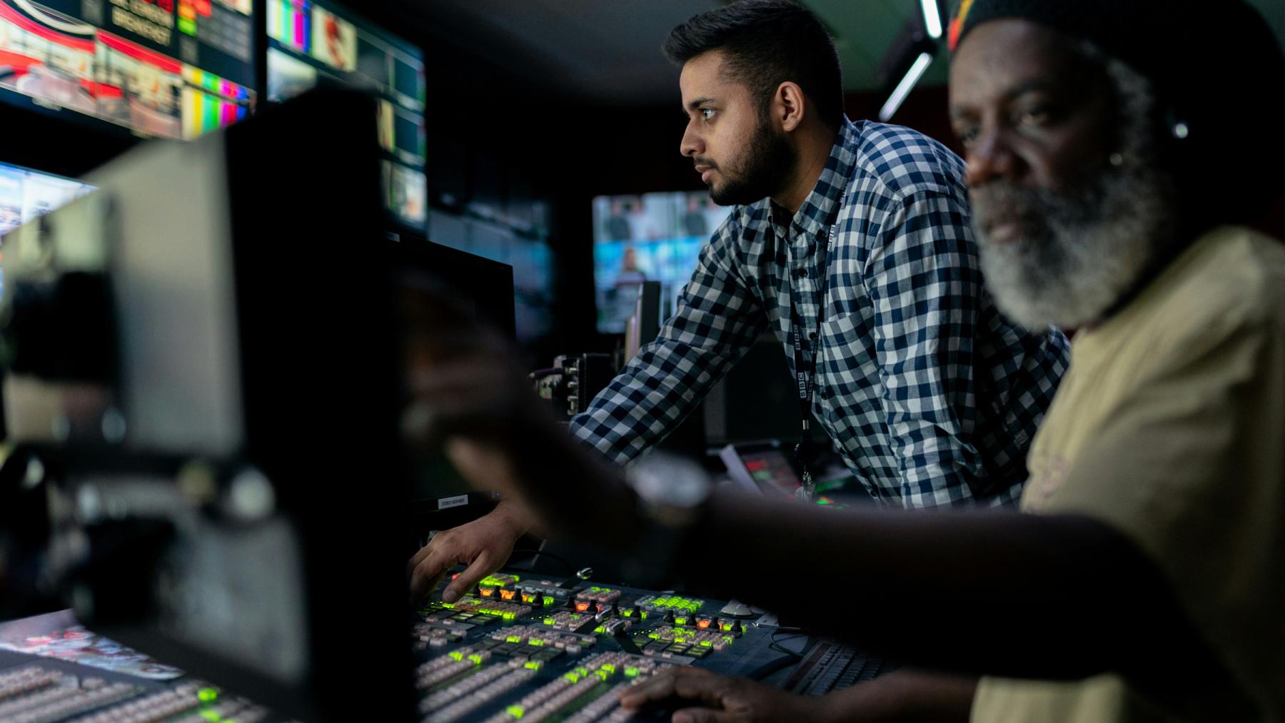 Two men working in a broadcast control room